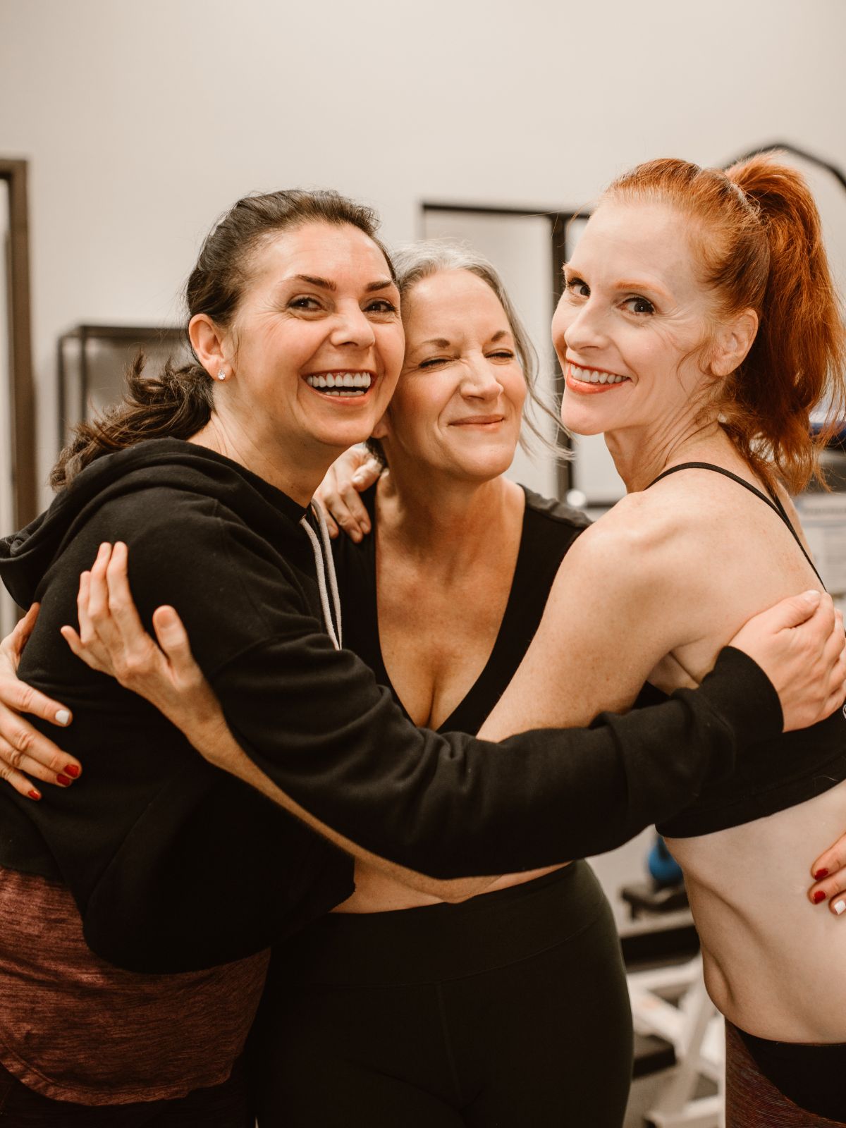 fit women smiling and huggling