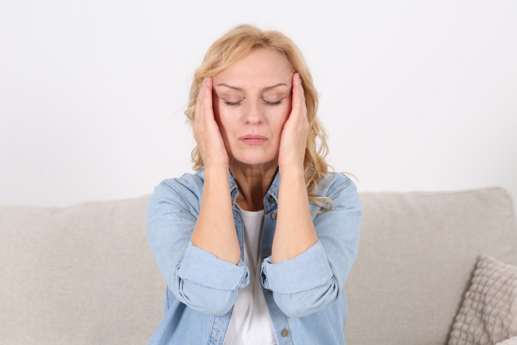Exhausted woman rubbing her temples