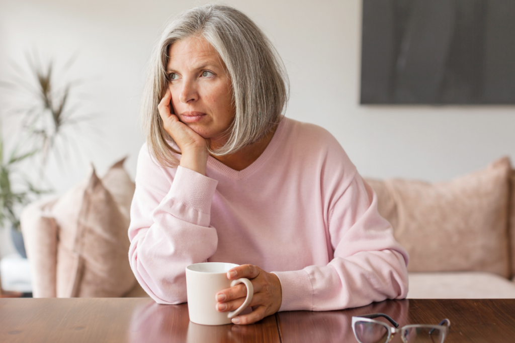 Woman leaning on her hand with a cup of coffee